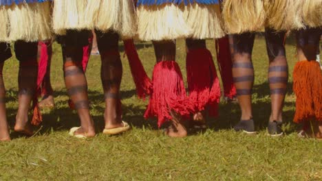 slow motion of indigenous dancers' decorated legs and skirts