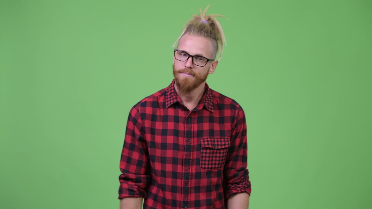 Stressed bearded hipster man with dreadlocks looking bored and tired