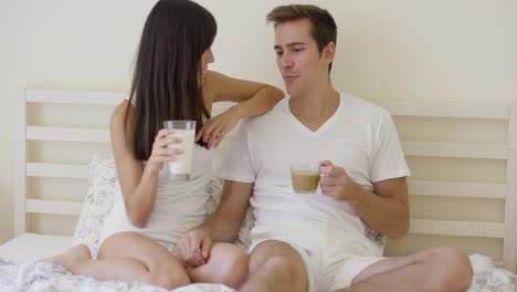 Man-and-woman-having-breakfast-in-bed