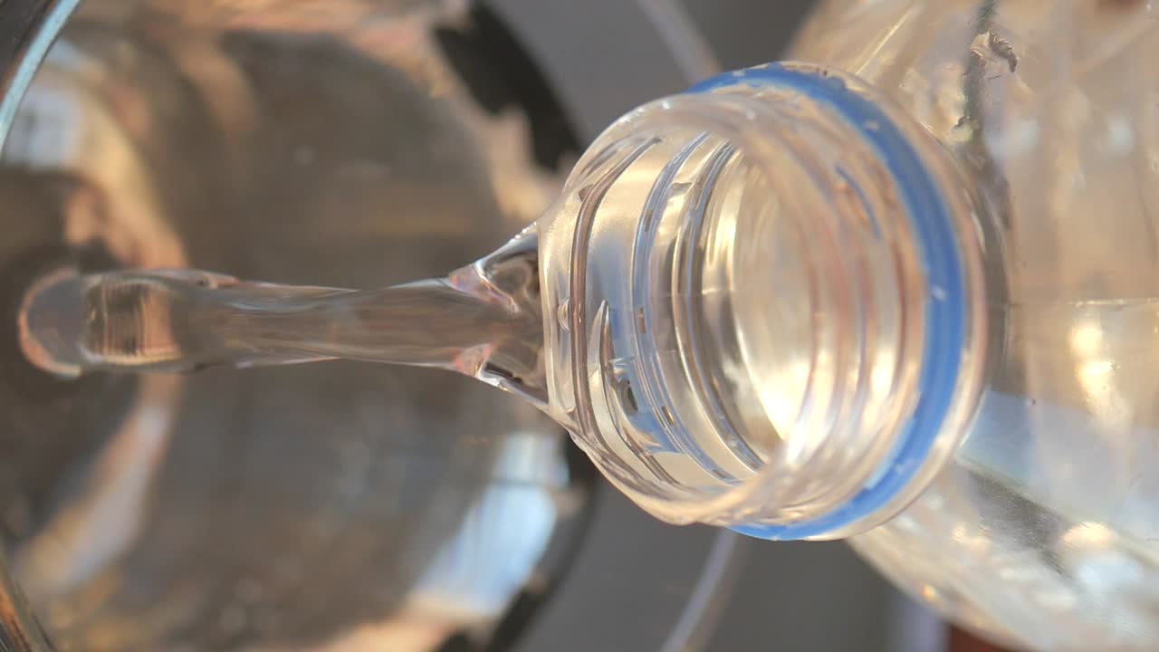 Water pouring from a plastic bottle
