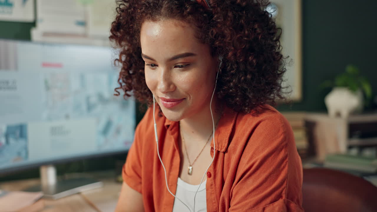 Woman with curly hair working on a tablet in the office