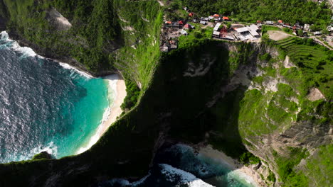 restaurants and hotels on the clifftop with kelingking and embon beach in nusa penida island, bali, indonesia