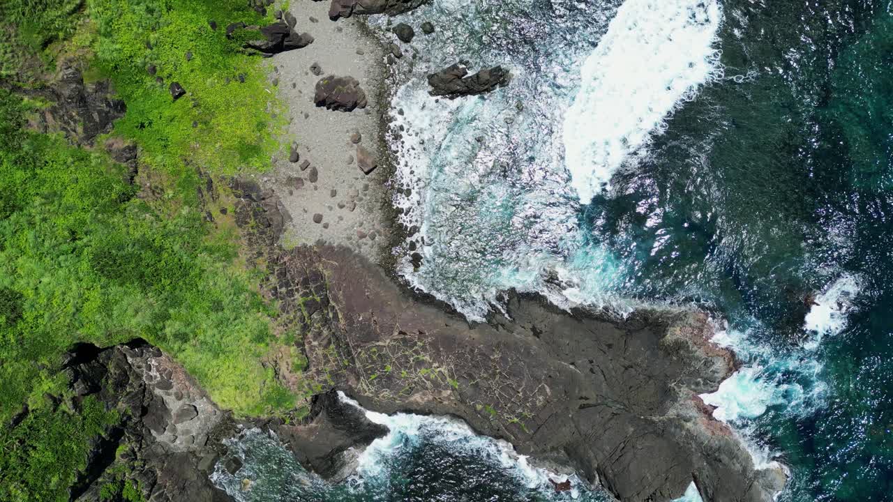 Picturesque top down view of tropical rocky ocean shore on a summer day
