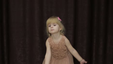 Happy-three-years-old-girl-make-faces-and-dancing.-Cute-blonde-child