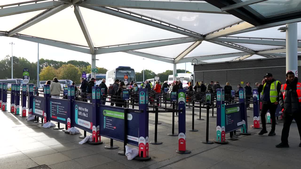 People Waiting at a Busy Bus Station