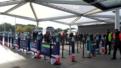 people waiting at a busy bus station