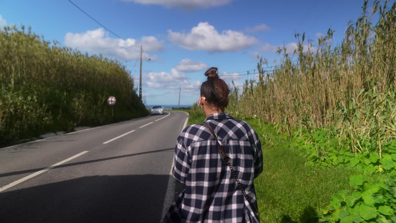 Woman walking on a country road