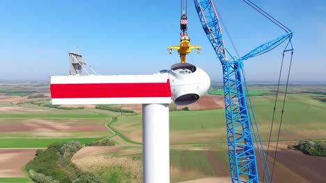 close up of wind turbine head construction in wind farm - drone shot