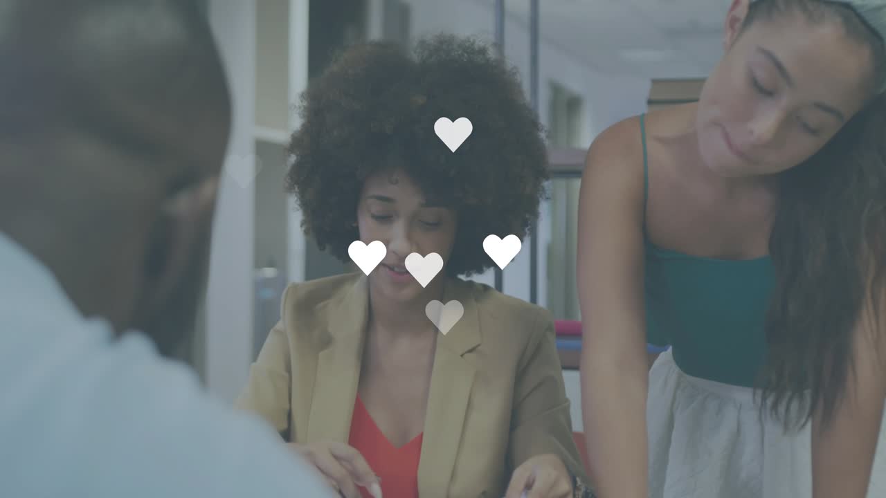 Office meeting woman pointing paper section and sparking floating heart icons while collaborating