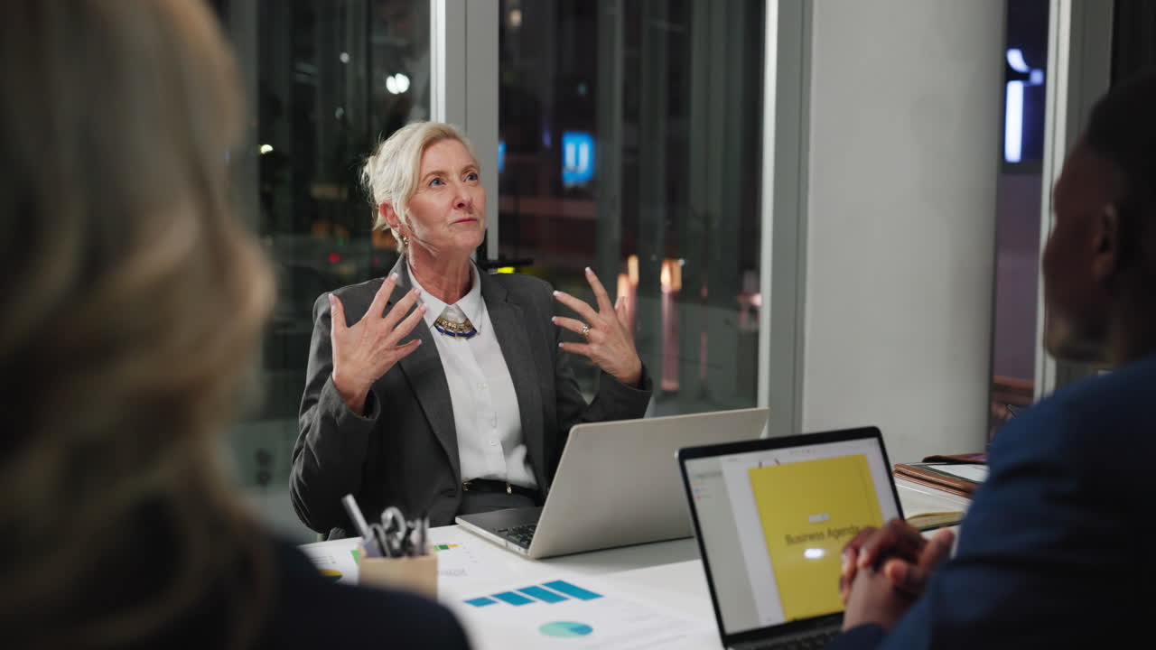 Experienced Businesswoman Speaking and Gesturing During an Office Meeting