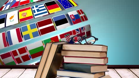 school books and glasses with european flags in globe shape