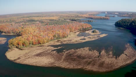 au sable river in michigan during fall colors with drone video moving forward wide shot