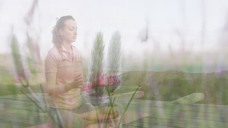 animation of landscape over caucasian woman practicing yoga and meditating