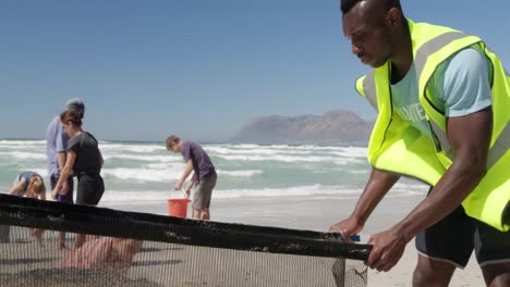 Volunteers-cleaning-beach-on-a-sunny-day-4k