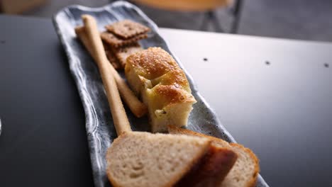 bread, crackers, and breadsticks on a plate