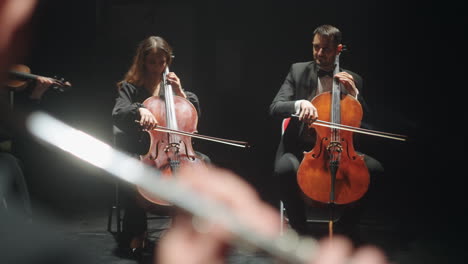 orchestra is rehearsing in philharmonic hall cellists are playing music string instrument