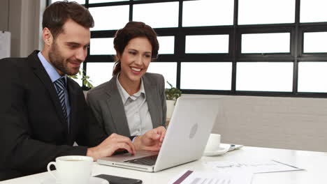 Business-colleagues-using-laptop