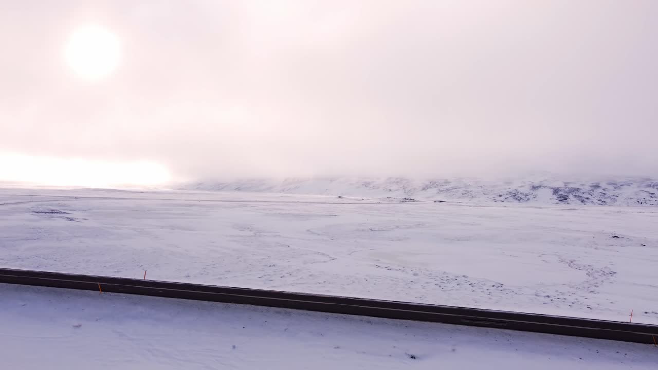 A sweeping aerial perspective showcases an expansive, pristine snow-covered wilderness stretching to the horizon in North Iceland