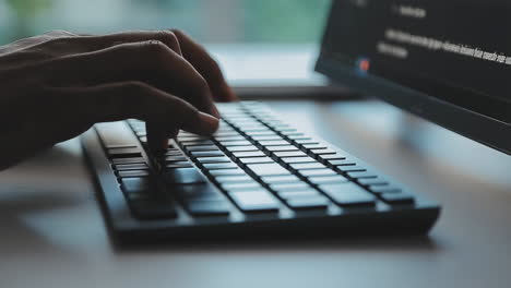 close-up of hands typing on a computer keyboard