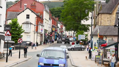 people and vehicles on a bustling town street