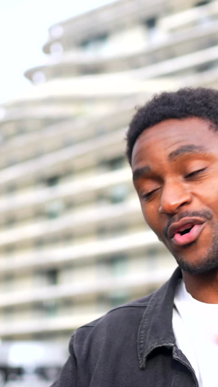 Man filming a vlog with a smartphone and microphone