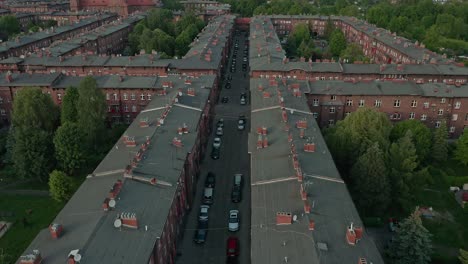 vehicles park at the street of redbrick apartments in nikiszowiec neighborhood in katowice, poland