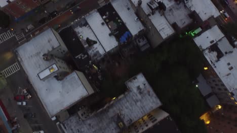 overhead evening aerial flying over brooklyn rooftops with cars driving the streets of nyc 4k