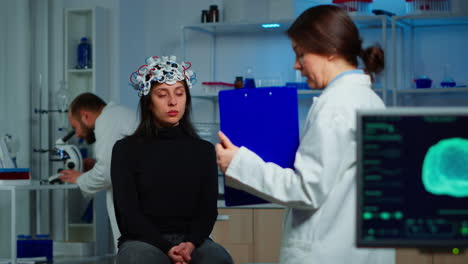 Neuroscience-doctor-holding-clipboard-showing-treatment-to-patient