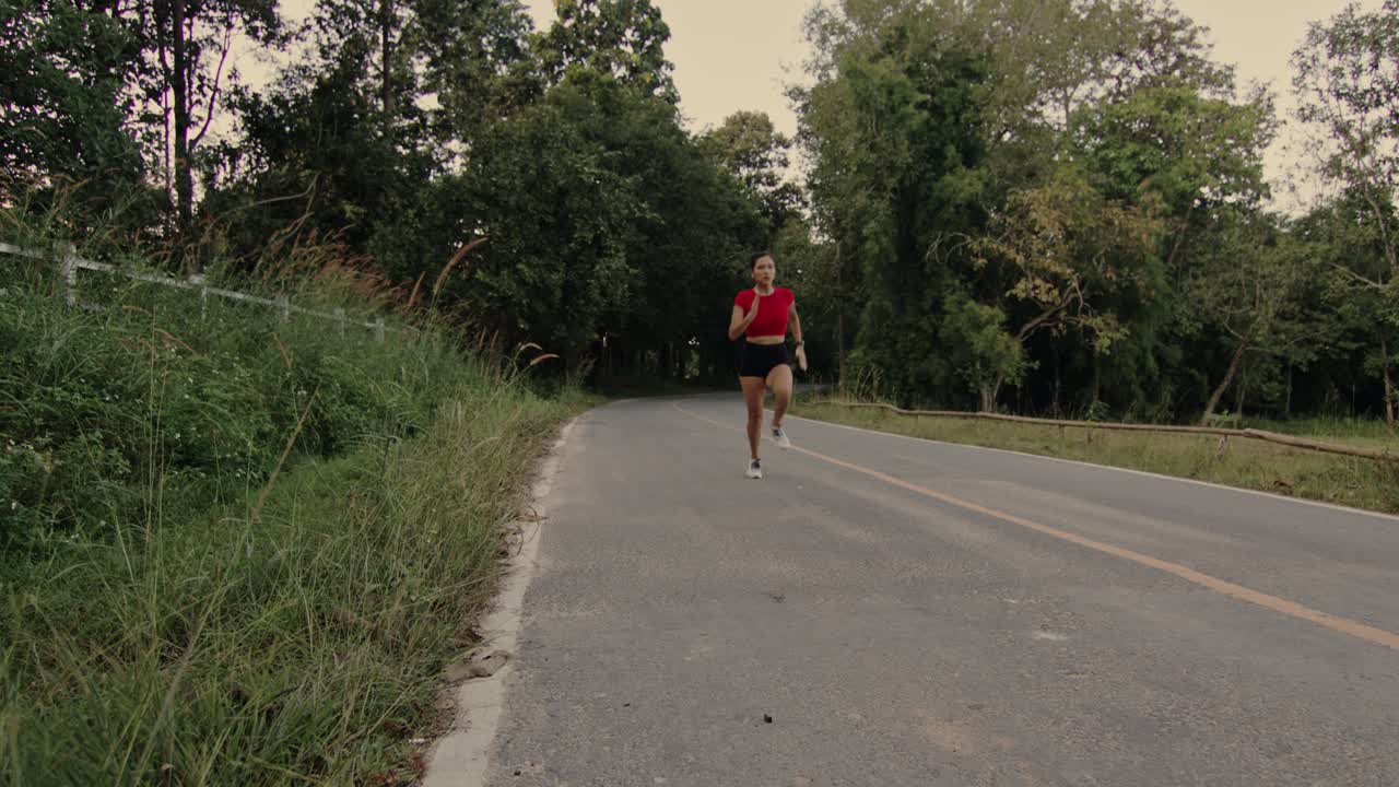 Woman Running Through Forest Trail