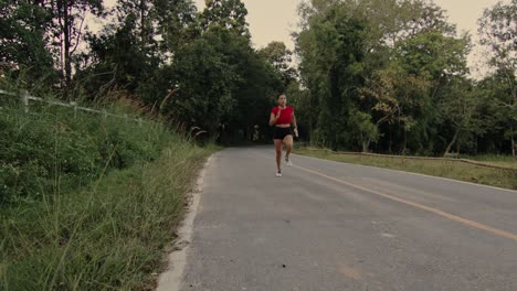woman running through forest trail
