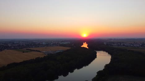 aerial view of incredible sunset reflected in river in slovakian nature