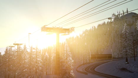 empty ski lift. chairlift silhouette on high mountain over the forest at sunset