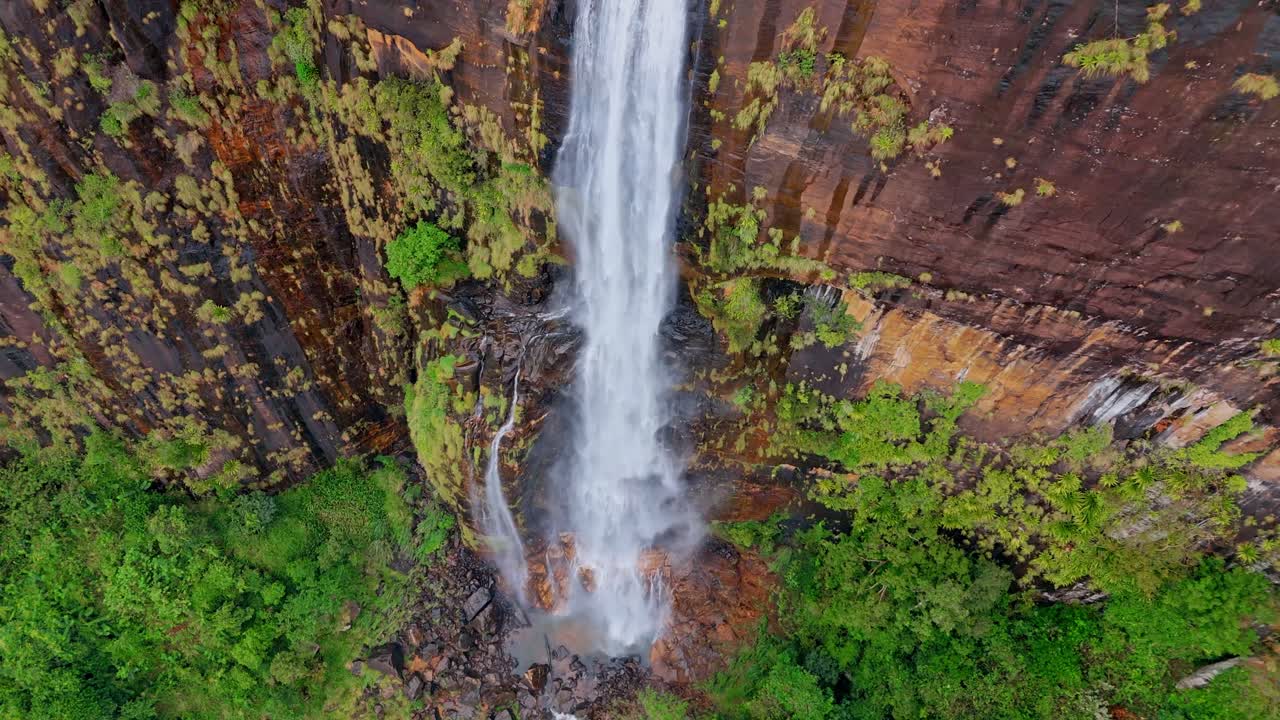 Experience the mystical allure of Diyaluma Falls as captured by aerial drone footage on a foggy day.