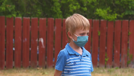 cute, young boy wearing a face covering to prevent the spread of coronavirus disease