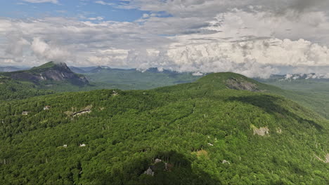 Highlands-North-Carolina-Aerial-v11-flyover-secluded-hillside-neighborhood-with-upscale-homes,-panoramic-panning-view-captured-rolling-mountain-landscape-in-summer---Shot-with-Mavic-3-Cine---July-2022