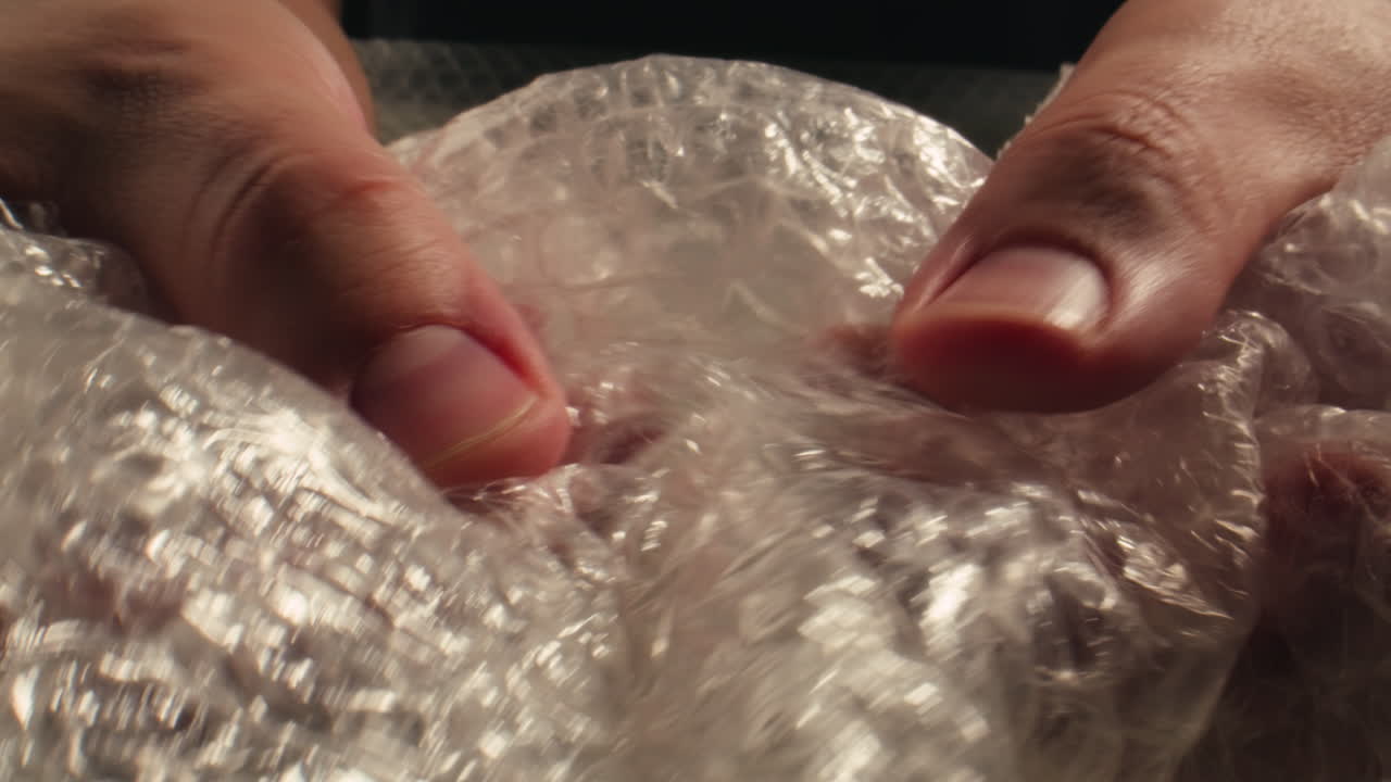 Close-up of Hands Popping Bubble Wrap for Stress Relief