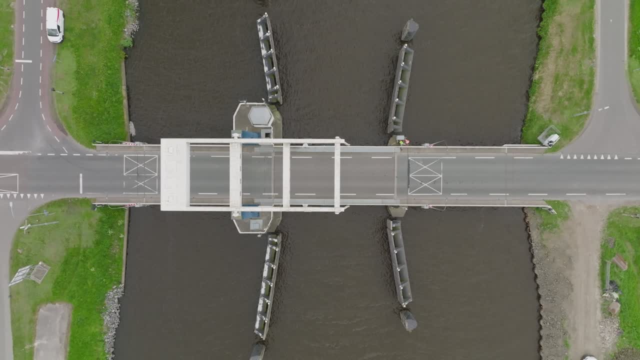 Nadir view of the bridge as a single car traverses the span; water, barriers and markings clearly seen