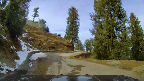 4x4 suv driving through narrow, curved and steep mountainous roads during winters