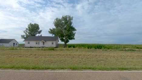 fields of crops and farms roll by on this country road drive