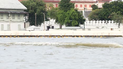 boats navigate the river in bangkok, thailand