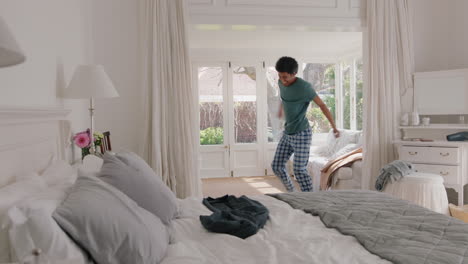 funny-young-man-dancing-in-bedroom-having-fun-celebrating-feeling-positive-enjoying-successful-lifestyle-doing-silly-dance-at-home-on-weekend-morning-wearing-pajamas