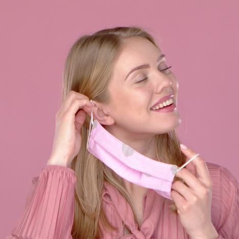 adorable smiling young girl taking on her face mask against viruses  slow motion video