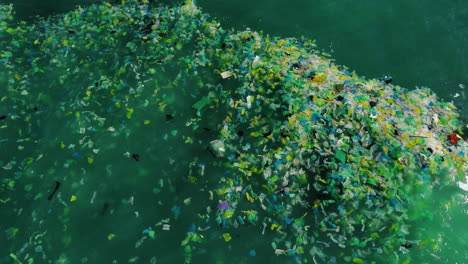 ocean water full of rubbish and plastics, aerial top down shot