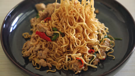 homemade stir-fried instant noodles with thai basil and minced pork - thai food style