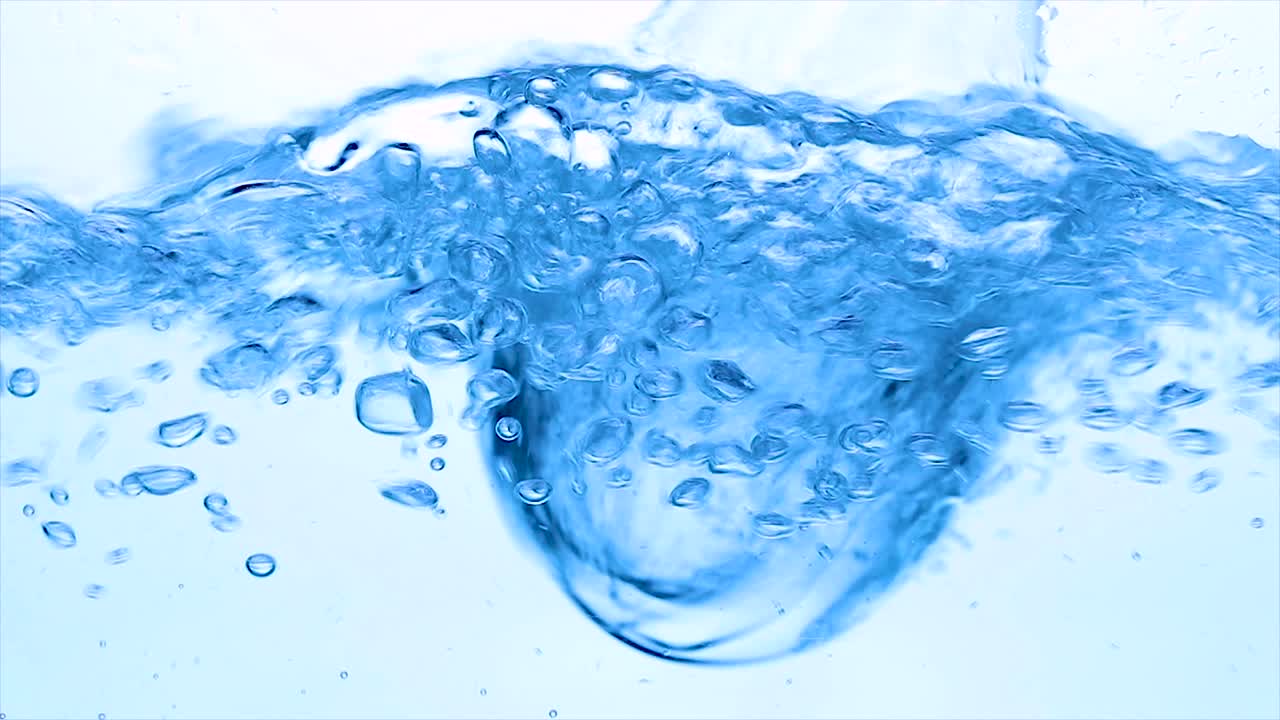 Water with a mixer whisk, slow-motion shooting.