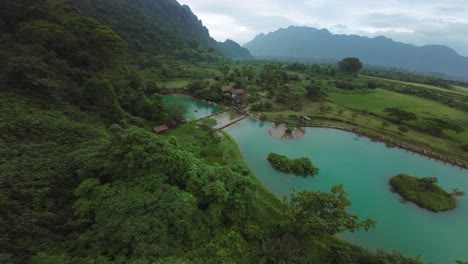 stunning aerial view of a blue lagoon in a lush green tropical landscape
