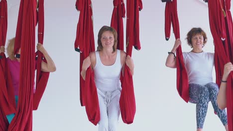 nice slim women have fun swinging in hammocks in room