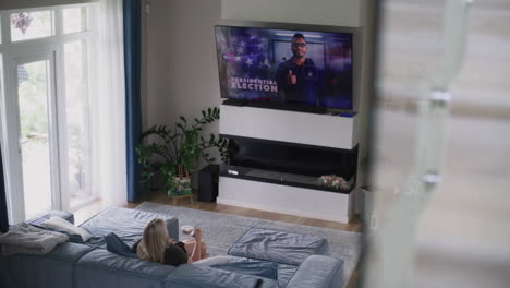 woman watching political news on tv