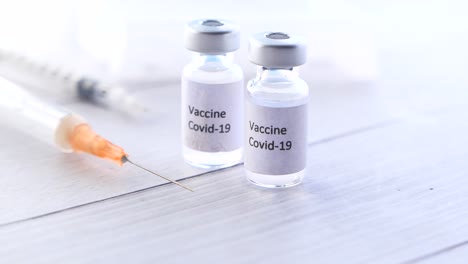 covid-19 vaccine vials and syringe