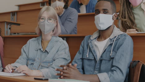 students in a lecture hall wearing masks